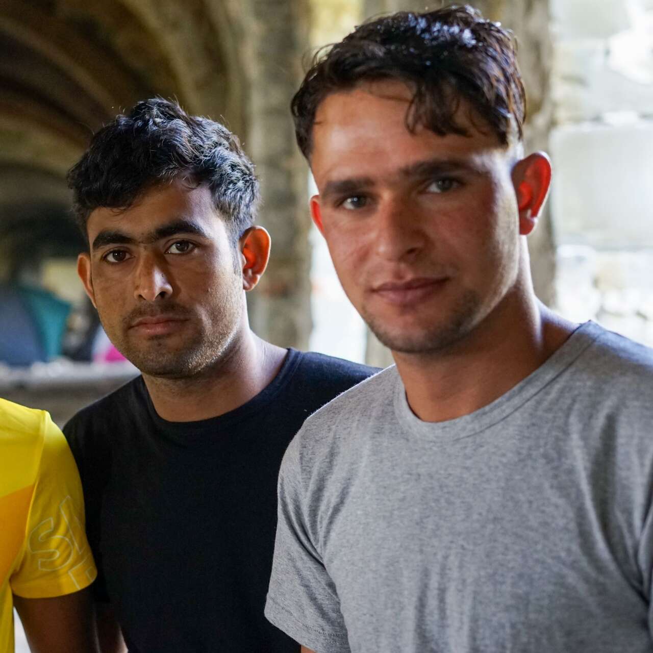 Three young asylum seekers sleeping rough in an abandoned building, Trieste, Italy